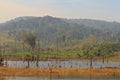Dead trees in the reservoir with blue sky - Thakhek Loop Royalty Free Stock Photo