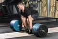 Deadlift attempt. Young man trying to lift heavy barbell Royalty Free Stock Photo