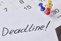 Deadline concept. A paper with Deadline text pinned on monthly calendar Royalty Free Stock Photo