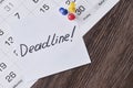 Deadline concept. A paper with Deadline text pinned on monthly calendar Royalty Free Stock Photo