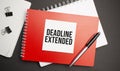 DEADLINE EXTENDED sign on sheet of paper on the red notepad with pen Royalty Free Stock Photo