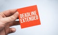 DEADLINE EXTENDED word on paper in businessman hands Royalty Free Stock Photo