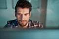 Deadline means overtime for him. a young businessman working late at the office. Royalty Free Stock Photo