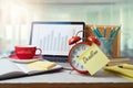 Deadline and time management concept with alarm clock on office table with computer laptop. Business background for design