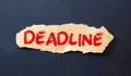 Deadline word written on a post note and hanged on the cork-board with an old pocket watch