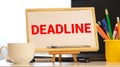 Deadline word written on a post note and hanged on the cork-board with an old pocket watch Royalty Free Stock Photo