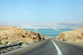 Deadseaview on a curvy sandy road on a highway that runs along the Dead Sea from one side and Edom Mountains at Arava Desert from