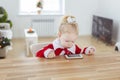 Deaf child girl with cochlear implant on living room with christmas tree - deafness diversity and innovative hearing aid Royalty Free Stock Photo