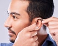 Deaf, cochlear and asian man ear in studio with hearing aid, audio and implant installation. Audiology, sound waves and Royalty Free Stock Photo