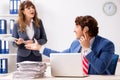 The deaf employee using hearing aid talking to boss Royalty Free Stock Photo