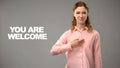 Deaf female saying you are welcome in asl, text on background, interpreter Royalty Free Stock Photo