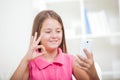 Deaf girl talking using sign language on the smartphone's cam