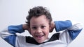 Deaf boy covering his ears stock photo Royalty Free Stock Photo