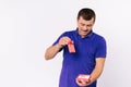 Deaf man surprised to receive a hearing aid in a red gift box. White background and empty sidewall space. Royalty Free Stock Photo