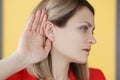 Deaf-mute woman holding her hand near ear Royalty Free Stock Photo