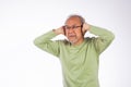Portrait senior old man with glasses sad covering ears with fingers hands Royalty Free Stock Photo