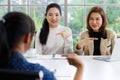 Deaf translator teaching two businesswomen to use and understand hand language sign