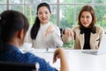 Deaf translator teaching two businesswomen to use and understand hand language sign