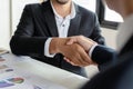 Deal. business people handshake after business signing contract document on desk in meeting room Royalty Free Stock Photo