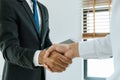 Deal. business people handshake after business signing contract document on desk in meeting room Royalty Free Stock Photo