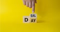 Deal of the Day symbol. Businessman hand points at turned cube with words Deal of the Day. Beautiful yellow background. Business