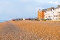 View along red stony beach with old-fashioned fishing boats pulled up and Beach Street buildings at sunrise Royalty Free Stock Photo