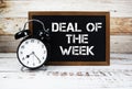 Deal of the Week text message and alarm clock on wooden background Royalty Free Stock Photo