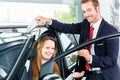 Dealer, female client and auto in car dealership