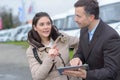 Dealer and female customer buying caravan