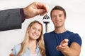 Dealer Handing Over Keys For New Car To Young Couple Royalty Free Stock Photo