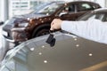 Dealer holding keys to a new car. Modern and prestigious vehicles Royalty Free Stock Photo