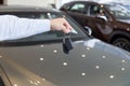 Dealer holding keys to a new car. Modern and prestigious vehicles Royalty Free Stock Photo