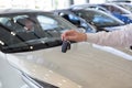 Dealer holding keys to a new car. Modern and prestigious vehicles Royalty Free Stock Photo