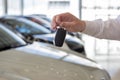 Dealer holding keys to a new car. Modern and prestigious vehicles Royalty Free Stock Photo