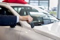 Dealer holding keys to a new car. Modern and prestigious vehicles. Royalty Free Stock Photo