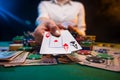 The dealer or player opens winning cards, two aces. A lot of money, chips, a casino and online gaming business. Poker, or black Royalty Free Stock Photo