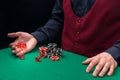 The dealer`s hands roll the dice on the green cloth of the poker table Royalty Free Stock Photo