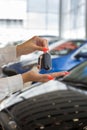 Dealer woman holding keys to a new car. Modern and prestigious vehicles Royalty Free Stock Photo