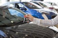 Dealer woman holding keys to a new car. Modern and prestigious vehicles Royalty Free Stock Photo