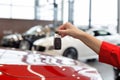 Dealer woman holding keys to a new car. Modern and prestigious vehicles Royalty Free Stock Photo