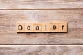 Dealer word written on wood block. Dealer text on wooden table for your desing, concept Royalty Free Stock Photo