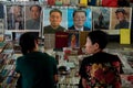 Dealers selling their antique books and famous chinese people posters at the Panjiayuan flea market in Beijing China