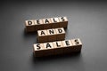 Deals and sales - phrase words from wooden blocks with letters