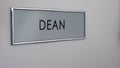 Dean office door, hand knocking, chief executive officer, school director