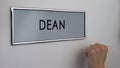 Dean office door, hand knocking closeup, visit to university department chief Royalty Free Stock Photo