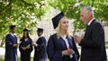 Dean talking with beautiful graduate female near academy, career and future