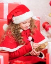Dear santa. Believe in miracle. Send letter for santa. Wish list. Child santa costume enjoy christmas eve. Girl hold pen