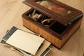 Dear to heart memorabilia in an old wooden box, lock of hair, stack of retro photos, vintage photographs of 40s - 50s, concept