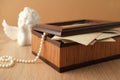 Dear to heart memorabilia in an old wooden box, pearl beads, stack of retro photos, vintage photographs of 40s - 50s, concept