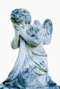 Death concept. Very ancient stone statue of crying angel  as symbol of end of human life. Image isolated on white background. Royalty Free Stock Photo